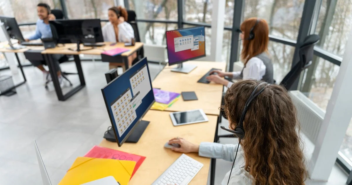 Team using integrated systems at office workstations